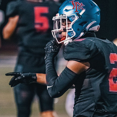 High School Football Player Wearing Cutters Rev Pro 5.0 Solid Receiver Gloves in Black Color