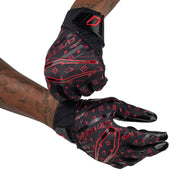 Cutters Sports Rev Pro 6.0 LE Receiver Football Gloves - Black/Red Lux - Football Player Pulling Glove Over Wrist for Better Fit