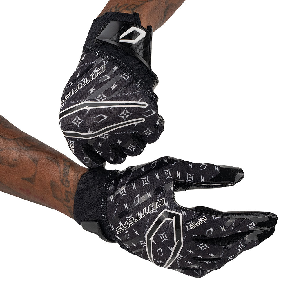 Cutters Sports Rev Pro 6.0 LE Receiver Football Gloves - Black/White Lux - Football Player Pulling Glove Over Wrist for Better Fit