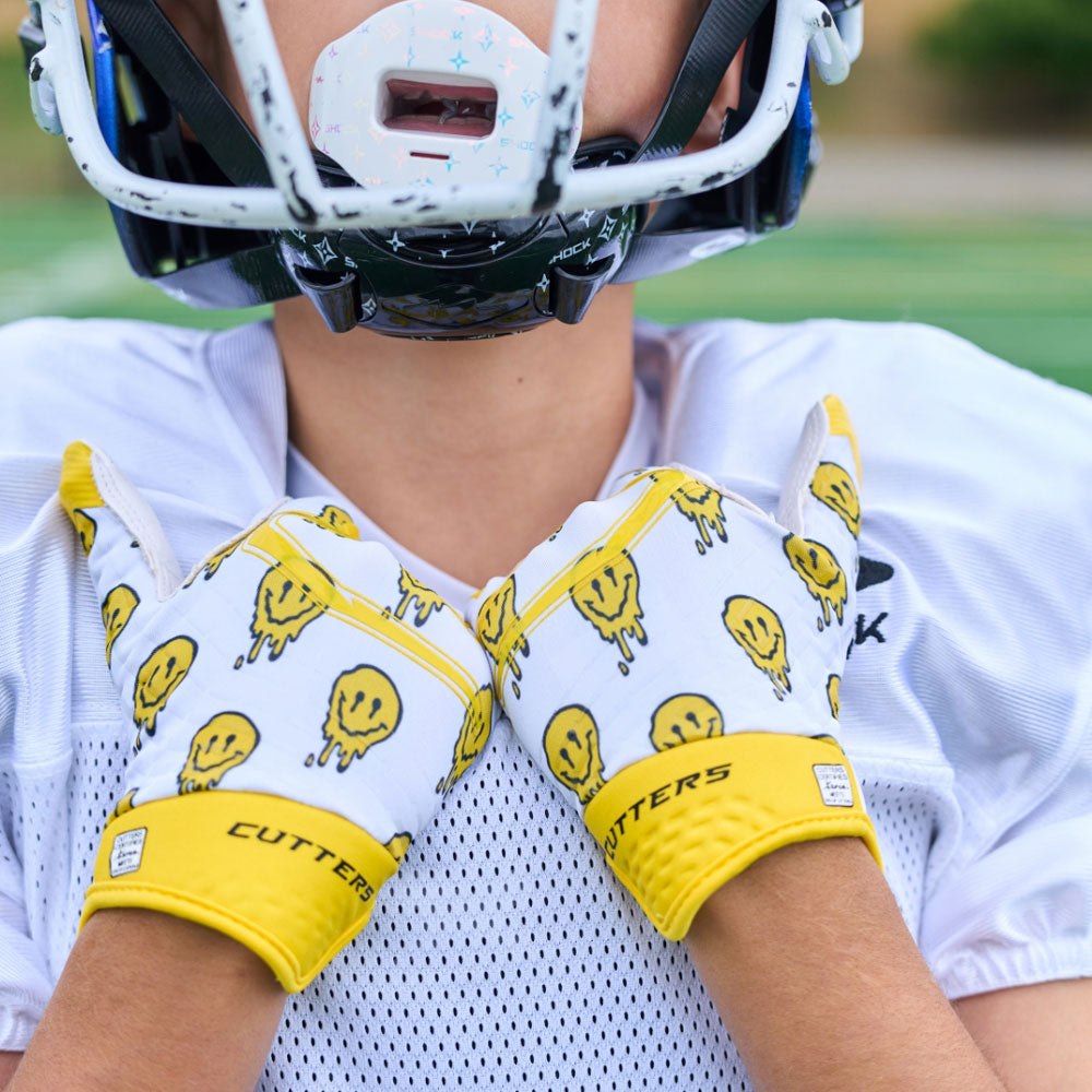 Lifestyle Image of Youth Football Player Wearing Smile Rev 5.0 Limited-Edition Youth Receiver Gloves