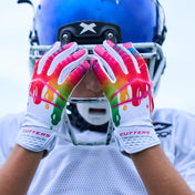 Lifestyle Image of Youth Football Player Wearing White/Multi Drip Rev 5.0 Limited-Edition Youth Receiver Gloves