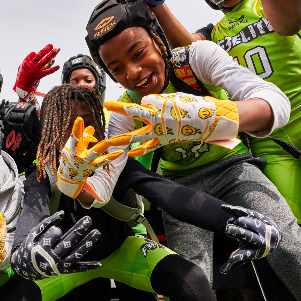 Youth 7v7 Football Player Wearing Cutters Smile Rev Pro 5.0 Limited-Edition Receiver Gloves