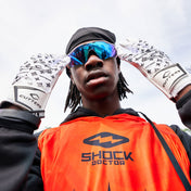 Youth 7v7 Football Player Wearing Cutters White/Black Lux Rev Pro 5.0 Limited-Edition Receiver Gloves