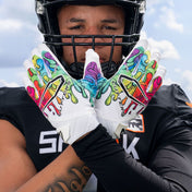 Athlete Wearing Cutters Rev Pro 6.0 LE Gloves in Multi Drip Print