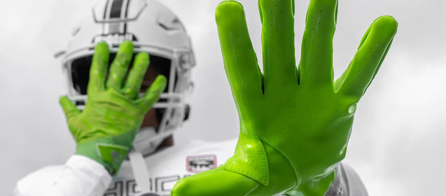 Youth Tackle Football Player Wearing Cutters Rev Pro 6.0 Solid Gloves in Shock Green
