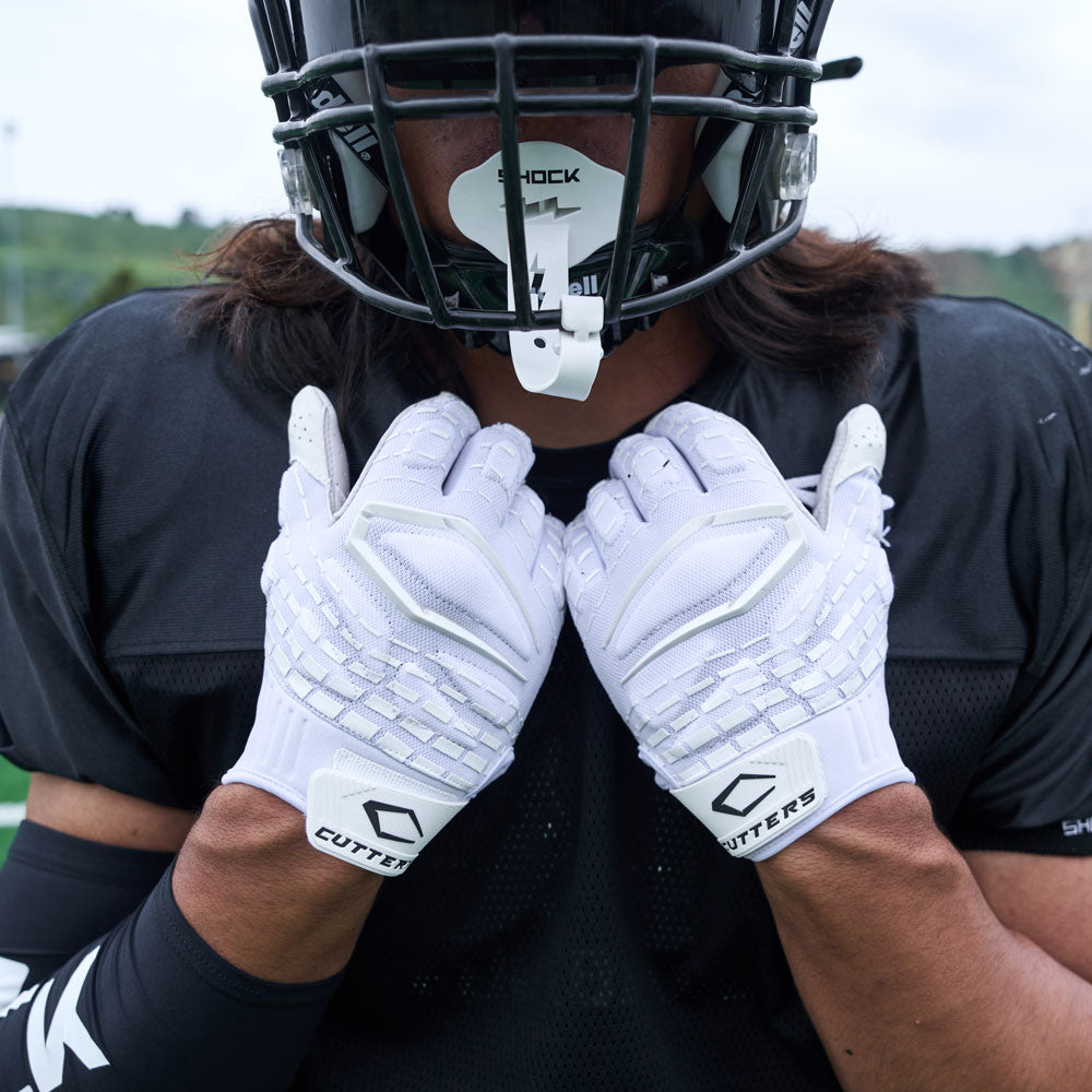 Lifestyle Detail Shot of Football Player Wearing Cutters Gamer 5.0 Padded Receiver Gloves in White