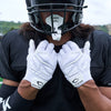 Lifestyle Detail Shot of Football Player Wearing Cutters Gamer 5.0 Padded Receiver Gloves in White