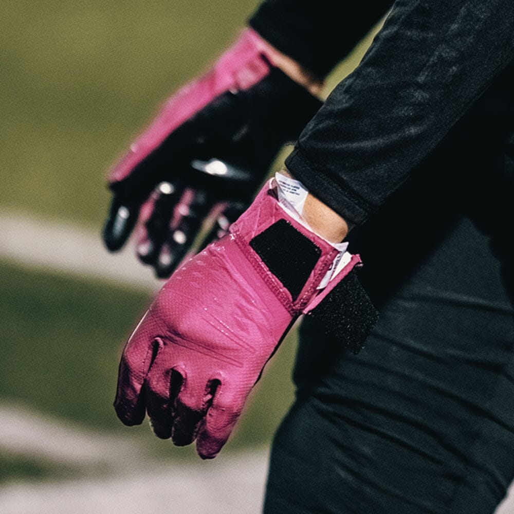 Detail Shot of High School Football Player Wearing Cutters Rev Pro 5.0 Solid Receiver Gloves in Pink Color