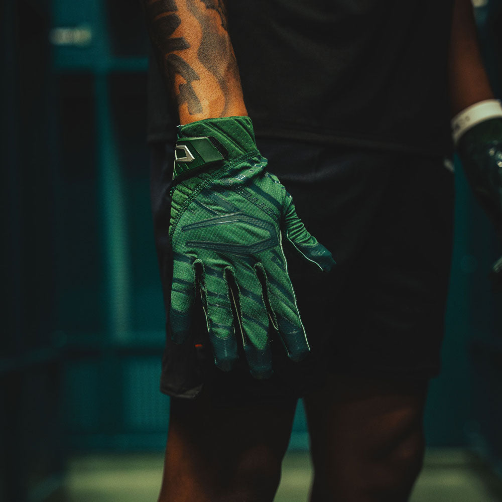 Youth 7v7 Football Athlete Wearing Cutters Sports Rev Pro 6.0 Solid Receiver Football Gloves in Dark Green