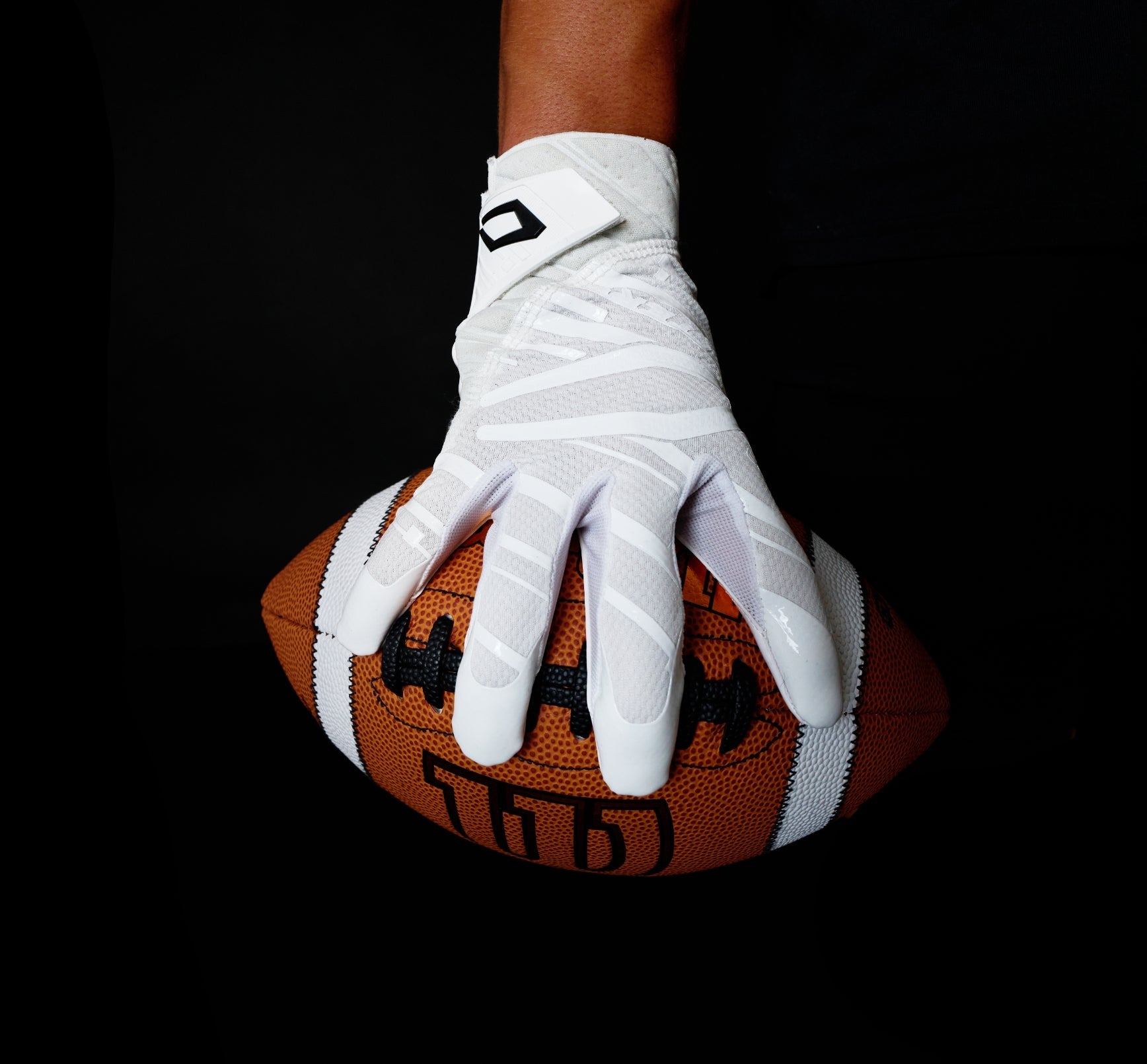 Image of Football Athlete Gripping Ball with  Cutters C-TACK Technology