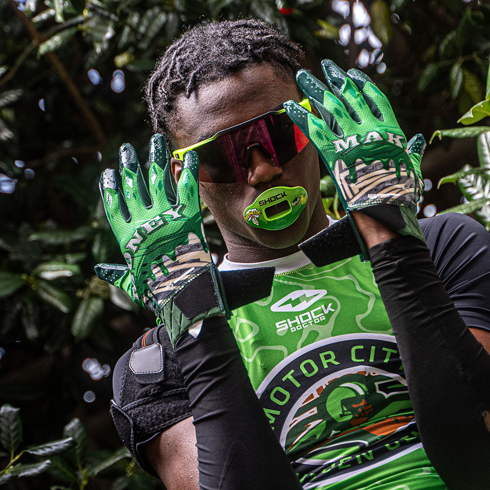 Lifestyle Image of Youth 7v7 Football Player Wearing Cutters Money Maker Rev Pro 5.0 Limited-Edition Receiver Gloves
