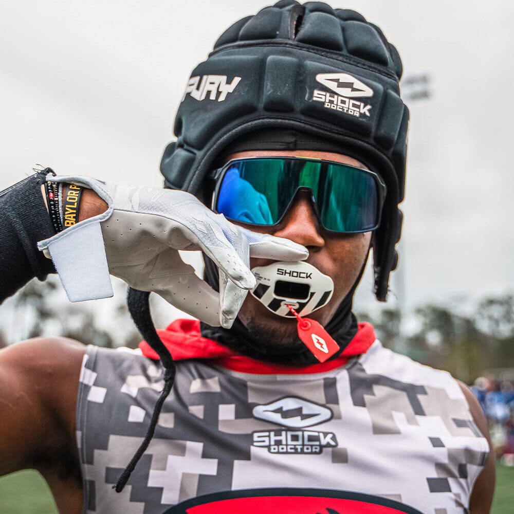 High School Football Player Wearing Cutters Rev Pro 5.0 Solid Receiver Gloves in White Color