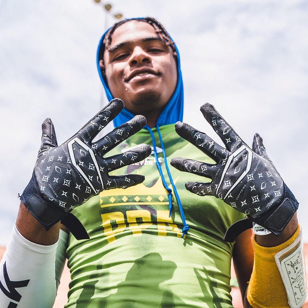 Youth Football Player Wearing Cutters Sports Black Lux Rev Pro 4.0 Limited Edition Receiver Gloves