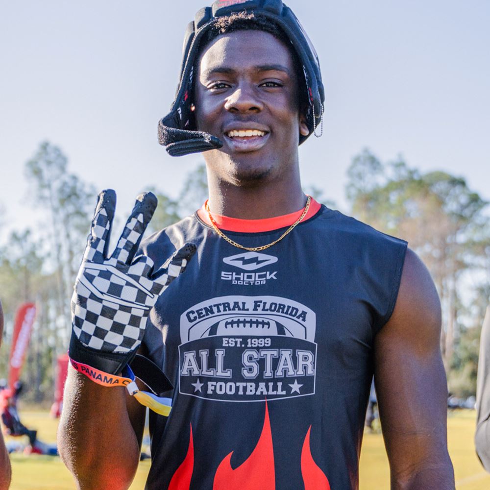 Youth Football Player Wearing Cutters Sports Checker Rev Pro 4.0 Limited Edition Receiver Gloves