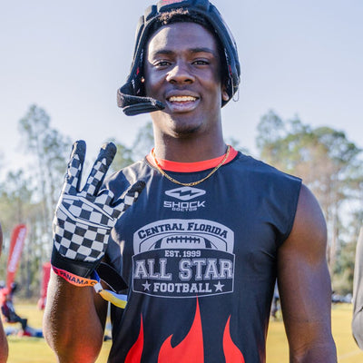 Youth Football Player Wearing Cutters Sports Checker Rev Pro 4.0 Limited Edition Receiver Gloves