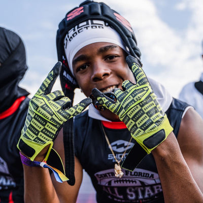 Youth Football Player Wearing Cutters Sports Danger Rev Pro 4.0 Limited Edition Receiver Gloves