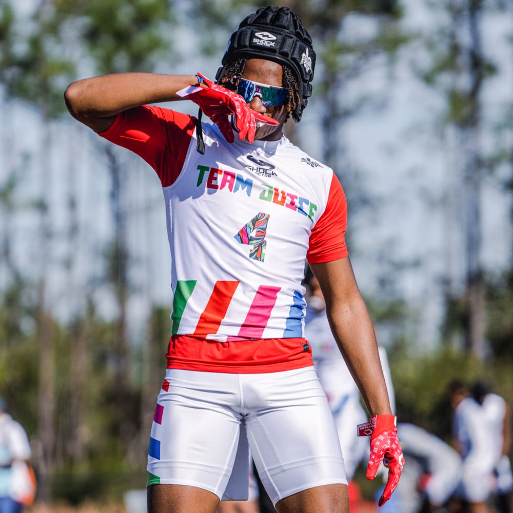 Youth Football Player Wearing Cutters Sports Red Lux Rev Pro 4.0 Limited Edition Receiver Gloves