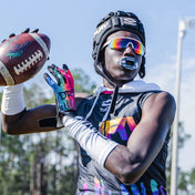 Youth Football Player Wearing Cutters Sports Tie Dye Rev Pro 4.0 Limited Edition Receiver Gloves