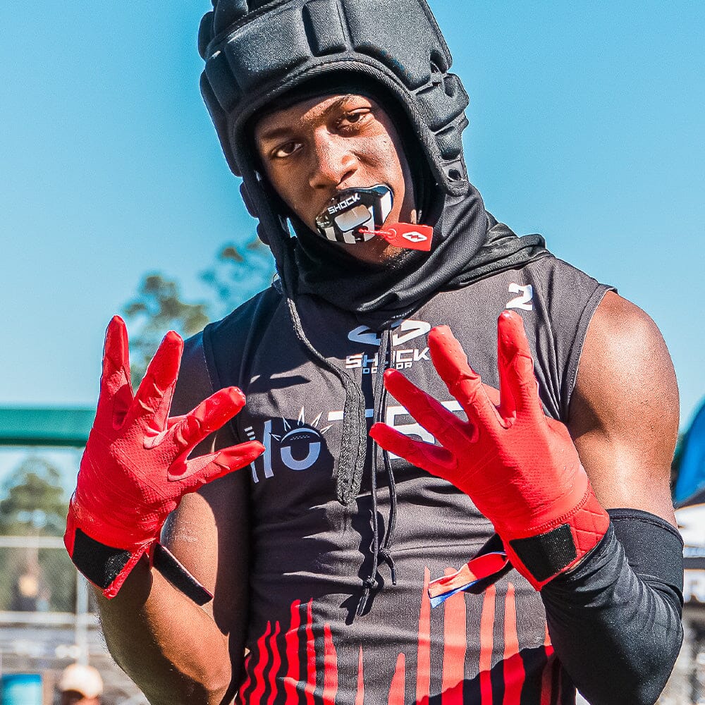 Youth Football Player Wearing Cutters Sports Red Rev Pro 5.0 Receiver Gloves