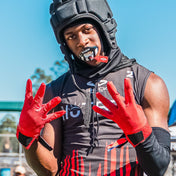 Youth Football Player Wearing Cutters Sports Red Rev Pro 5.0 Receiver Gloves