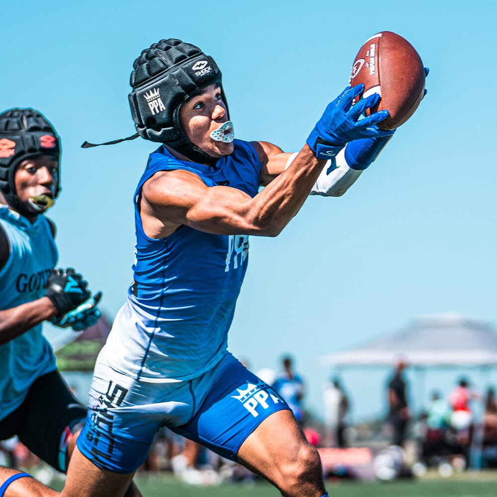 Youth Football Player Wearing Cutters Sports Royal Blue Rev Pro 5.0 Receiver Gloves