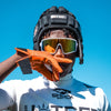 Youth Football Player Wearing Cutters Sports Orange Rev Pro 5.0 Receiver Gloves
